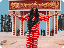 Woman in front of a historic monument in Benin